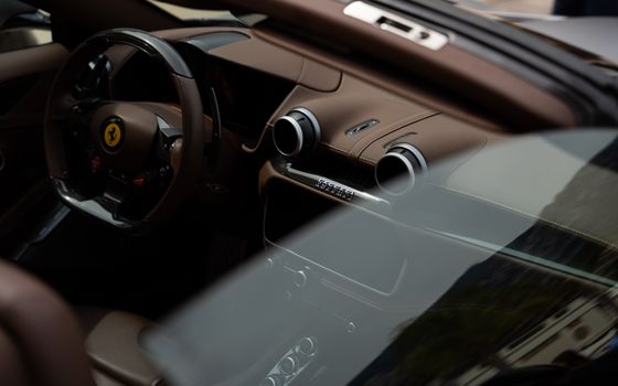 Close-up view of a luxury car interior showcasing the steering wheel and dashboard design.