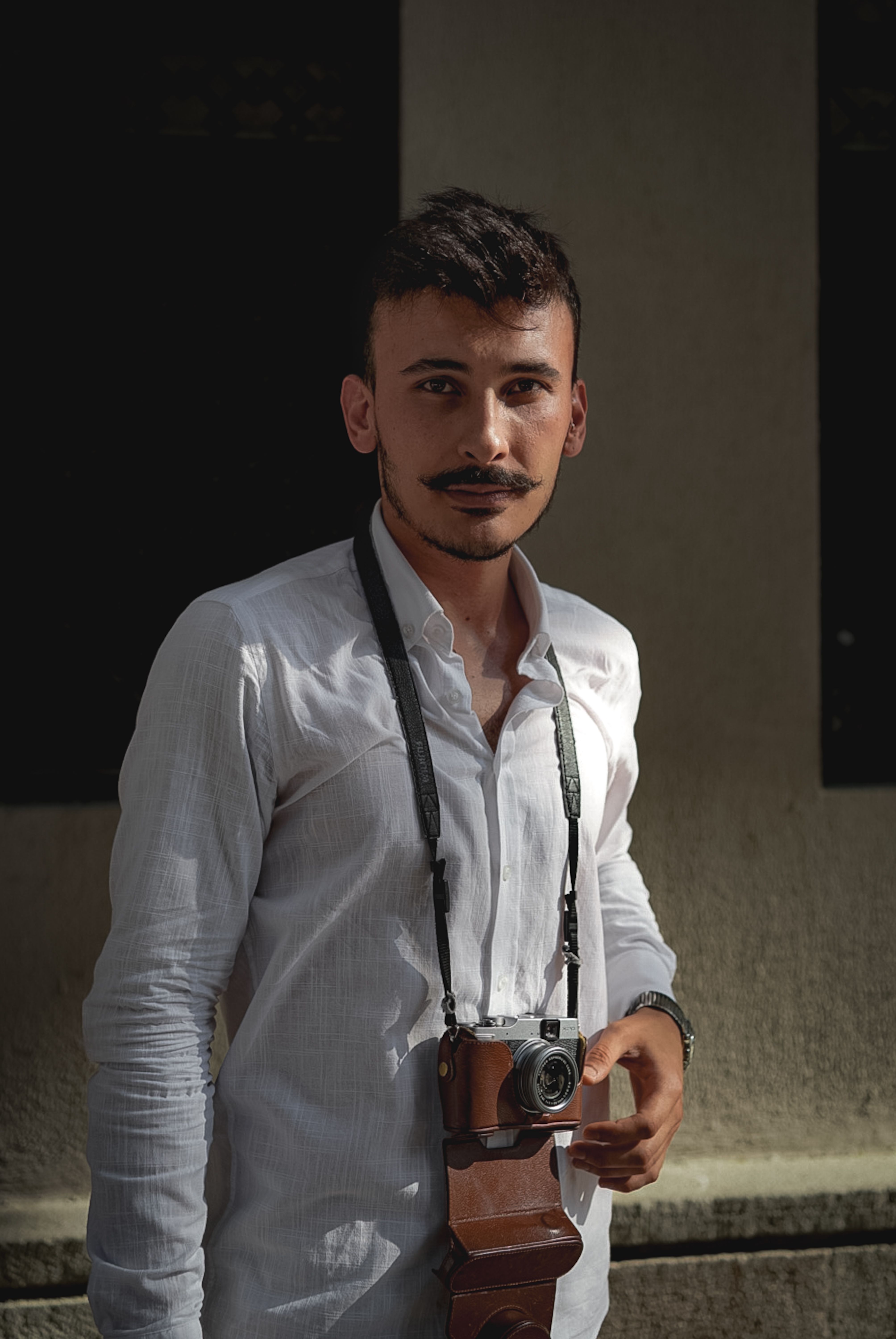 Man with a Mustache Carrying a Camera · Free Stock Photo