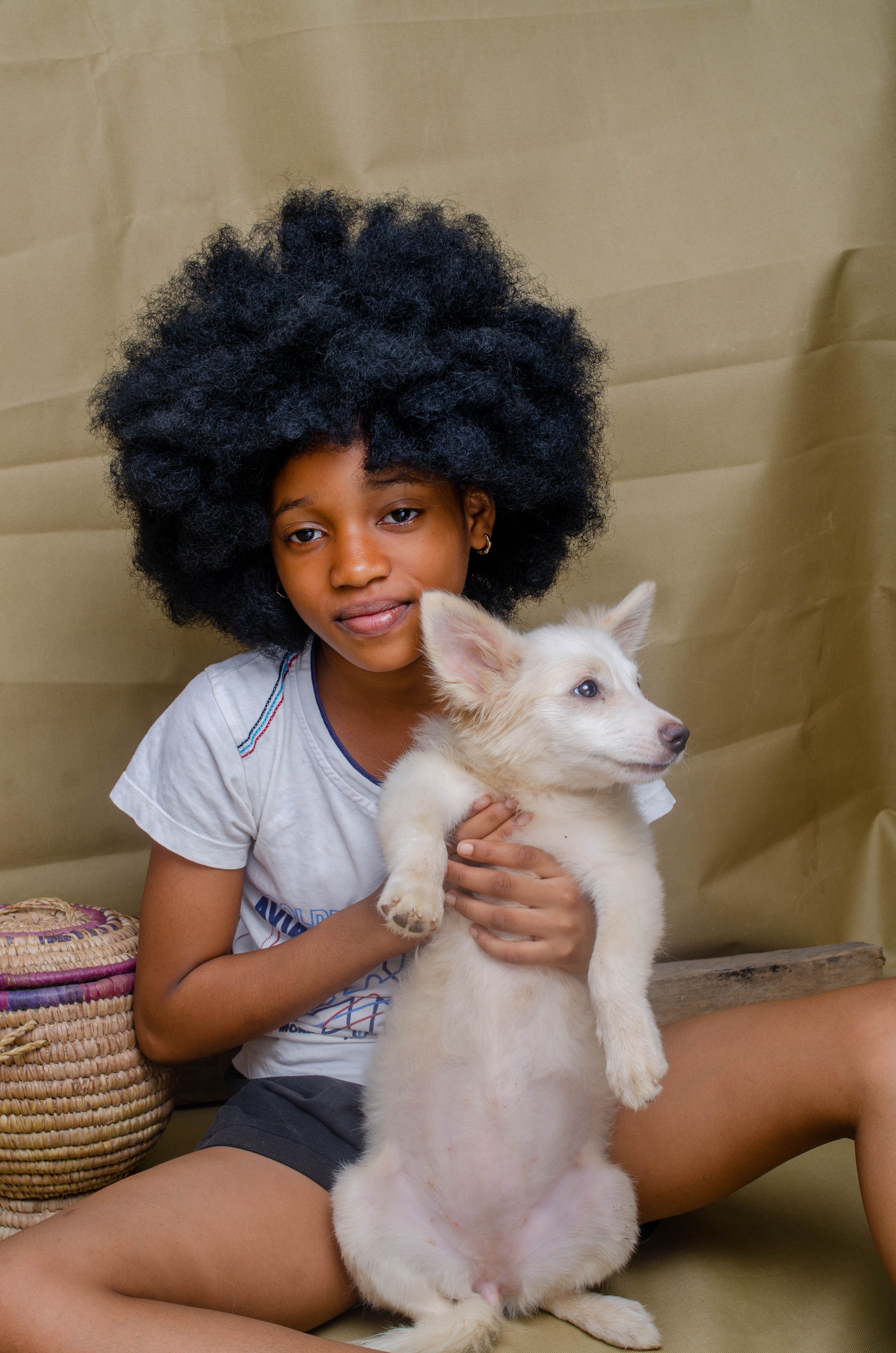 A Little Girl Sitting on the Floor with a Dog · Free Stock Photo