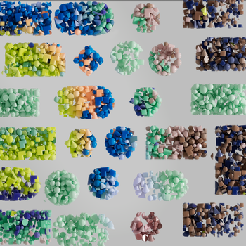 Vividly colored 3D geometric shapes arranged randomly against a gray backdrop, showcasing modern art.