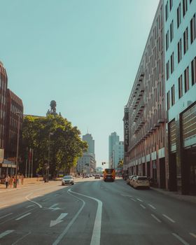 A vibrant city street scene with skyscrapers and clear blue sky, ideal for urban design themes.