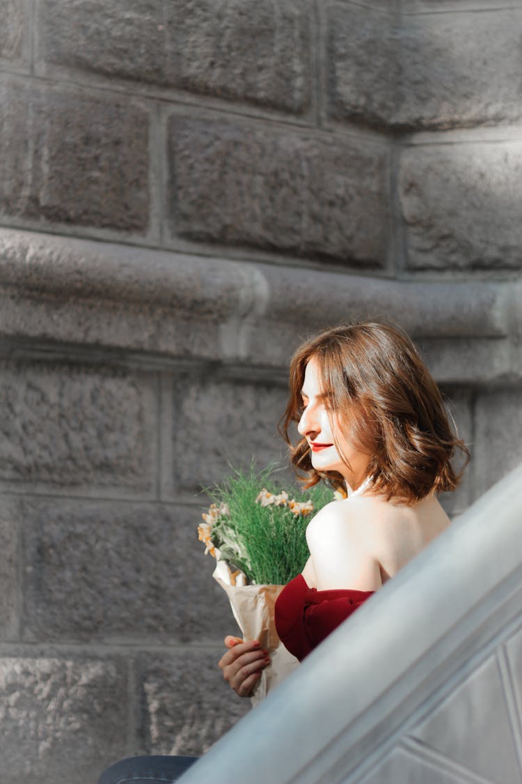 Young Woman With Flowers Walking Outdoor Staircase