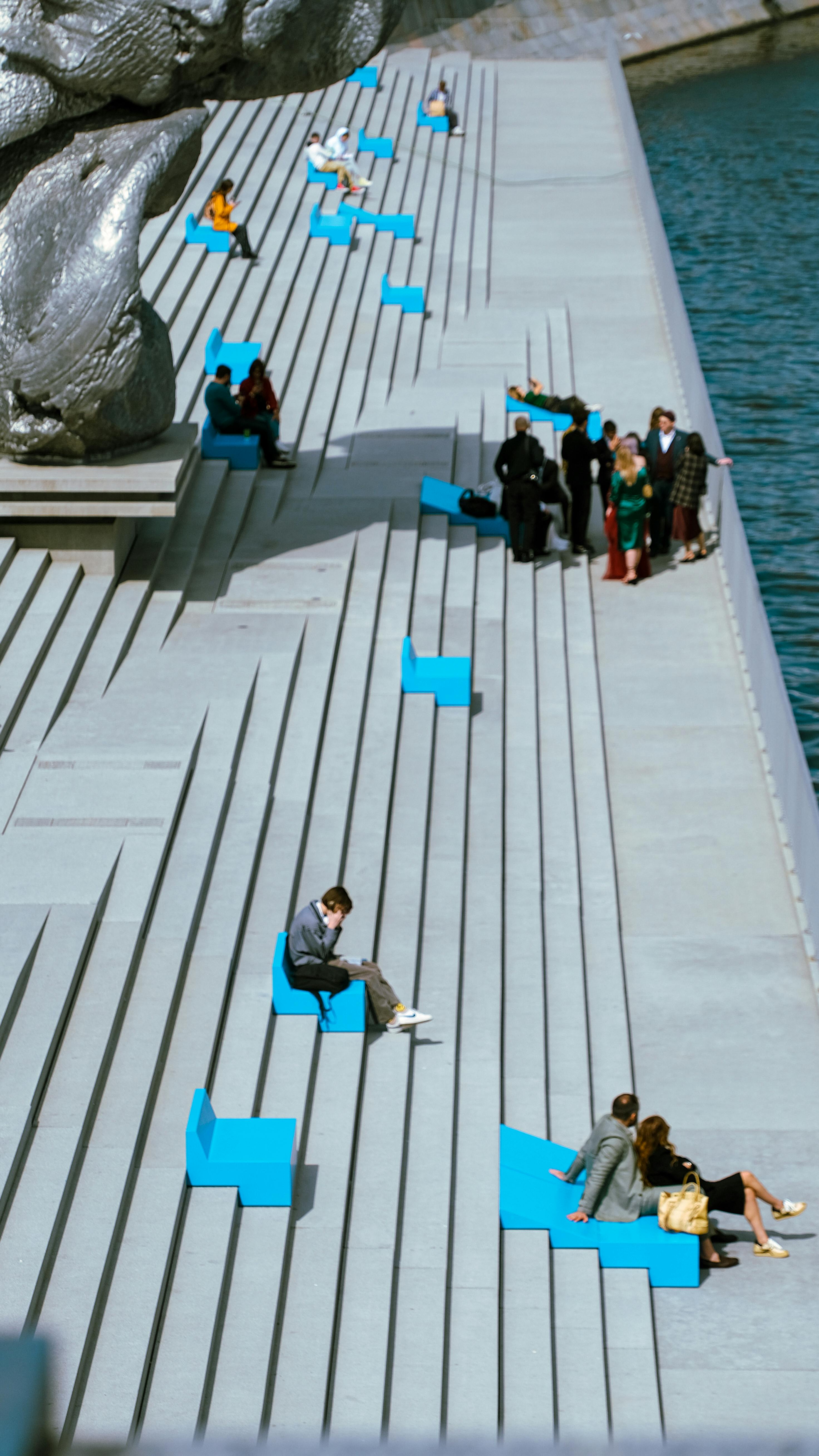 People Sitting and Standing on Waterfront Steps · Free Stock Photo