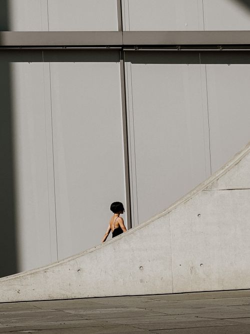 Free A woman walks by modern architecture in Berlin, Germany. Stock Photo