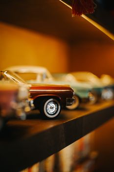 Charming close-up of vintage toy cars on a stylish shelf, evoking nostalgia and retro vibes.