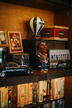 A collection of vintage figurines and items on a rustic bookshelf in Ankara.