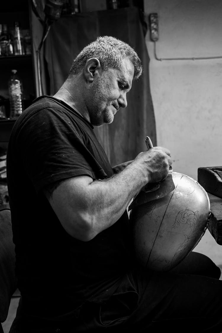 Black And White Picture Of An Artisan At Work 