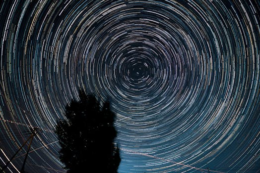 Captivating long exposure shot of star trails spiraling across the night sky.