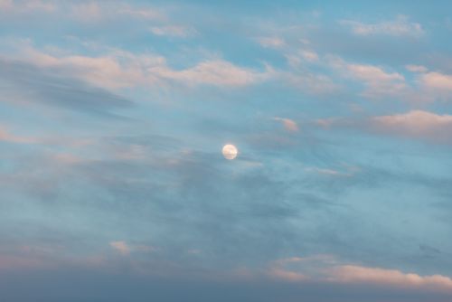 Free Calm sky featuring a bright moon and soft clouds during daylight. Stock Photo