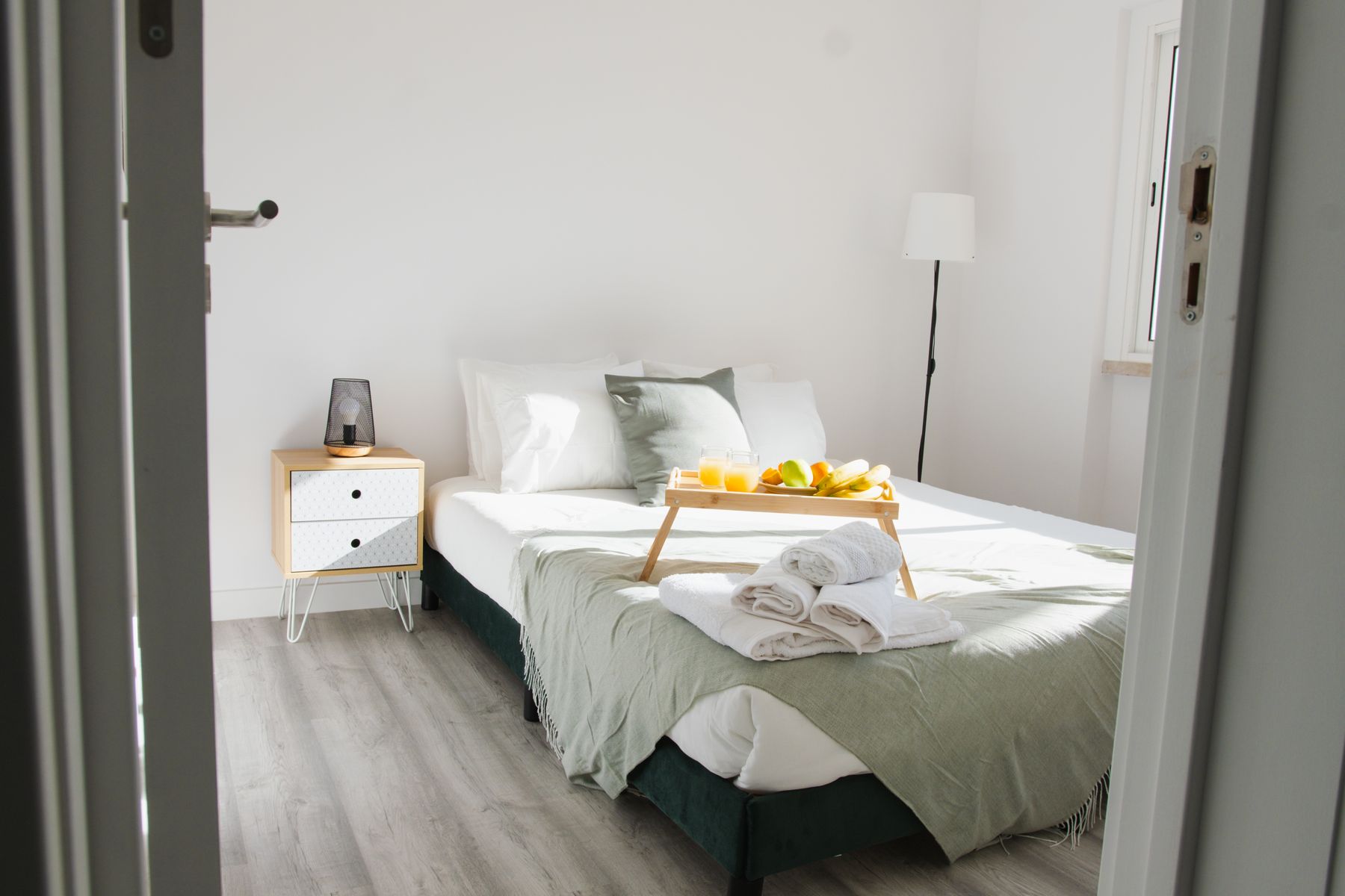 Warm bedroom with sandy wall color, oatmeal textiles and an ochre accent near the bed