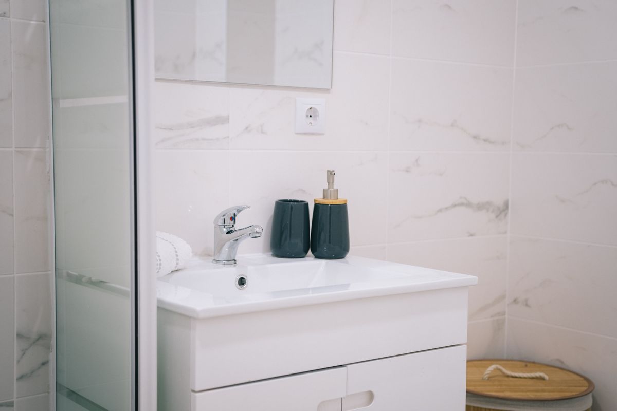 Modern bathroom with marble tiles and a wood vanity