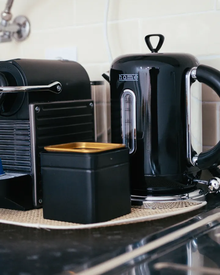 What Temperature Should a Refrigerator and Freezer Be? Black coffee maker and kettle on a modern kitchen counter