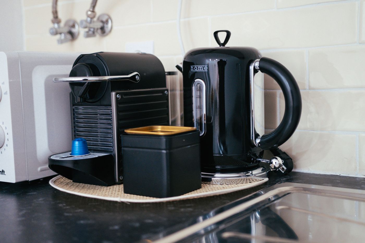 Coffee machine and electric kettle displayed together on a kitchen countertop