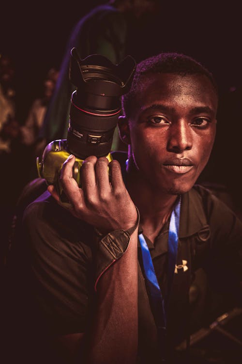 Man Holding a Digital Camera in Hand