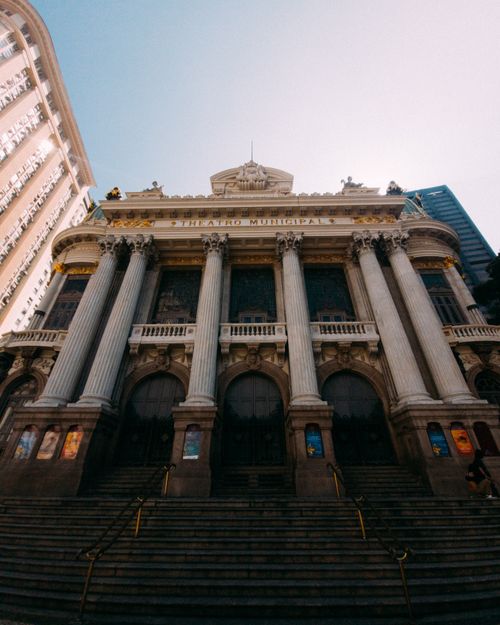 Free A low angle shot capturing the grand facade of Theatro Municipal in Rio de Janeiro in daylight. Stock Photo