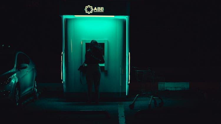 Back View Of A Woman Standing On The Background Of An Illuminated Building