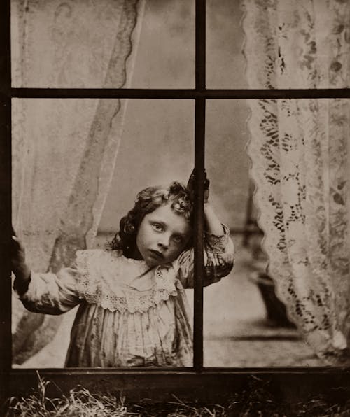 Little girl looking out of a window