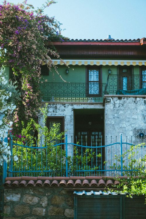 Free Picturesque rural house with colorful flowers and a classic facade. Stock Photo