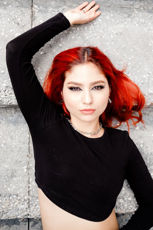 Young Woman Lying on a Concrete Ground 