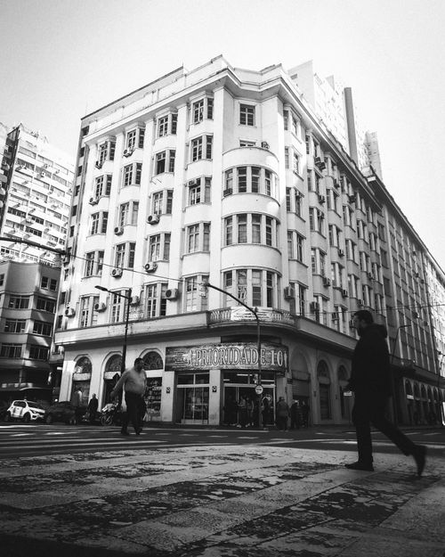 Free Black and white city scene showcasing historic architectural styles and urban life. Stock Photo
