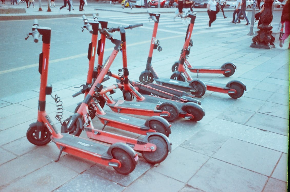 Free Electric Scooters on Sidewalk for Rent Stock Photo