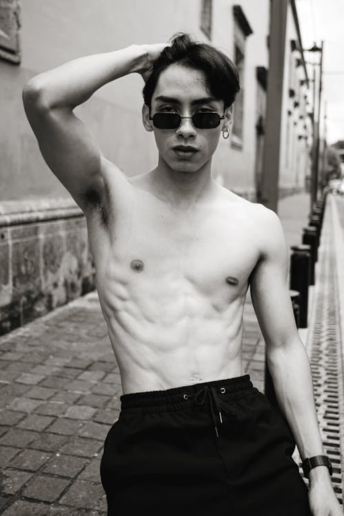 Young Topless Man in Sunglasses Posing on Street