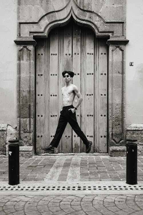 Young Topless Man Posing on City Paved Street