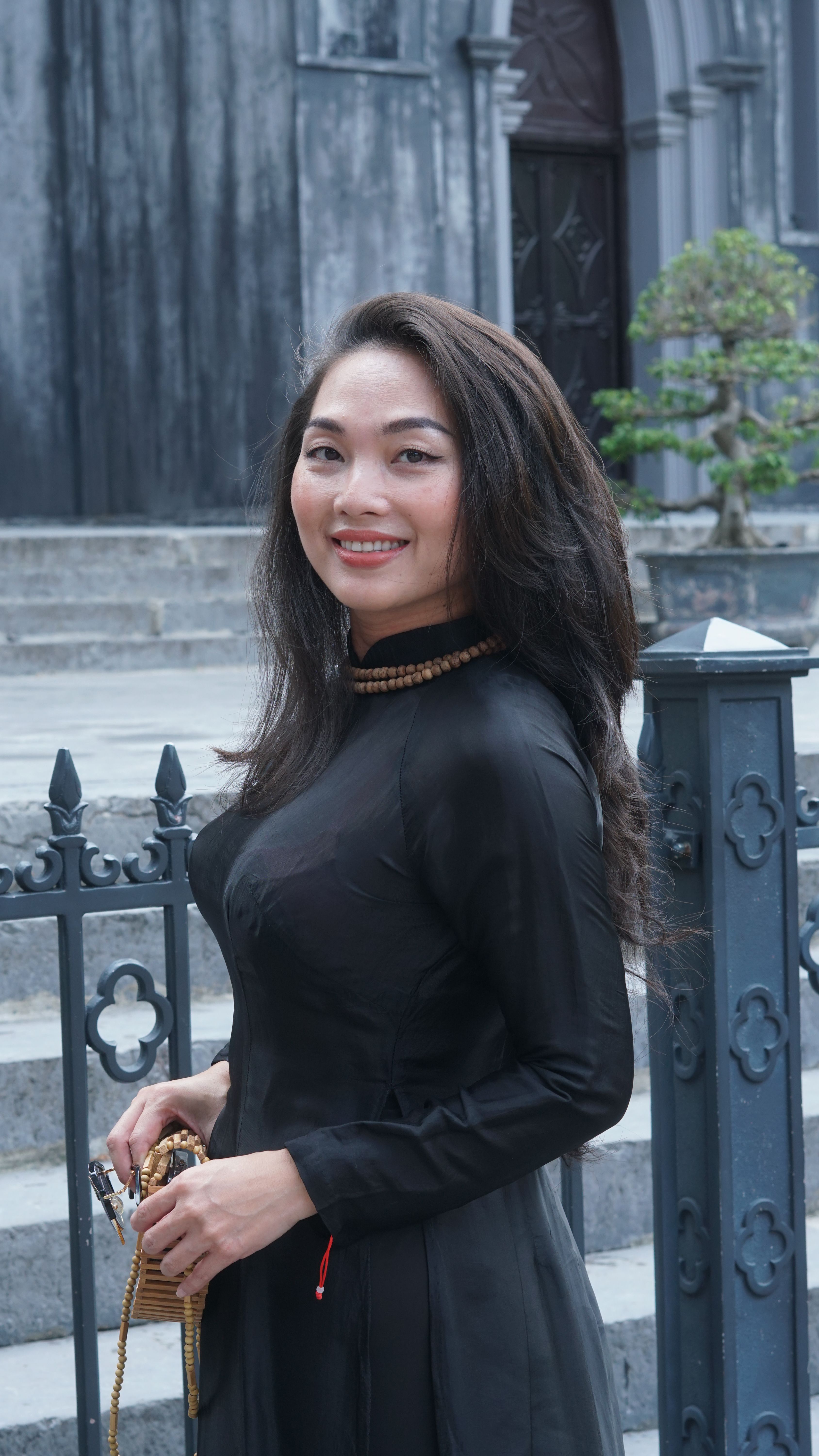 Smiling Brunette in a Black Dress · Free Stock Photo
