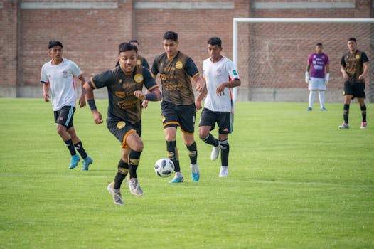 Soccer players in action on a green field during an intense match in Texcoco, Mexico.