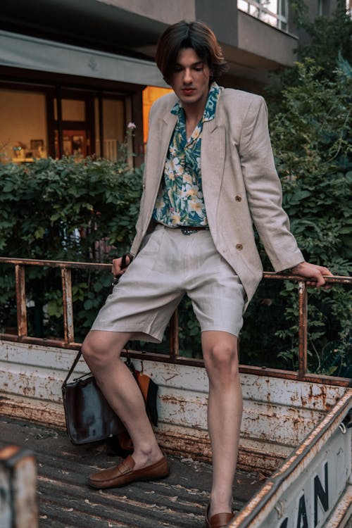 Elegant Man Posing at the Back of a Rusty Truck 