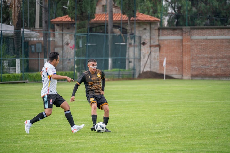 Player Is Passing Ball During Soccer Match