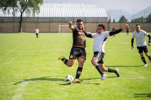 Players in action during a competitive soccer match outdoors in Texcoco, Mexico.