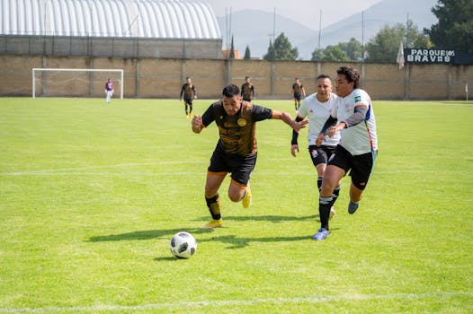 Dynamic soccer match showcasing players in action on a sunny day in Texcoco, Mexico.