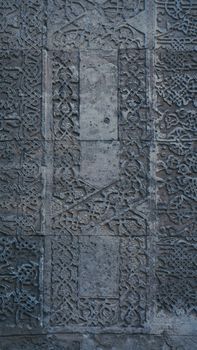 Ornate stone wall featuring detailed arabesque motifs and bas relief carvings.