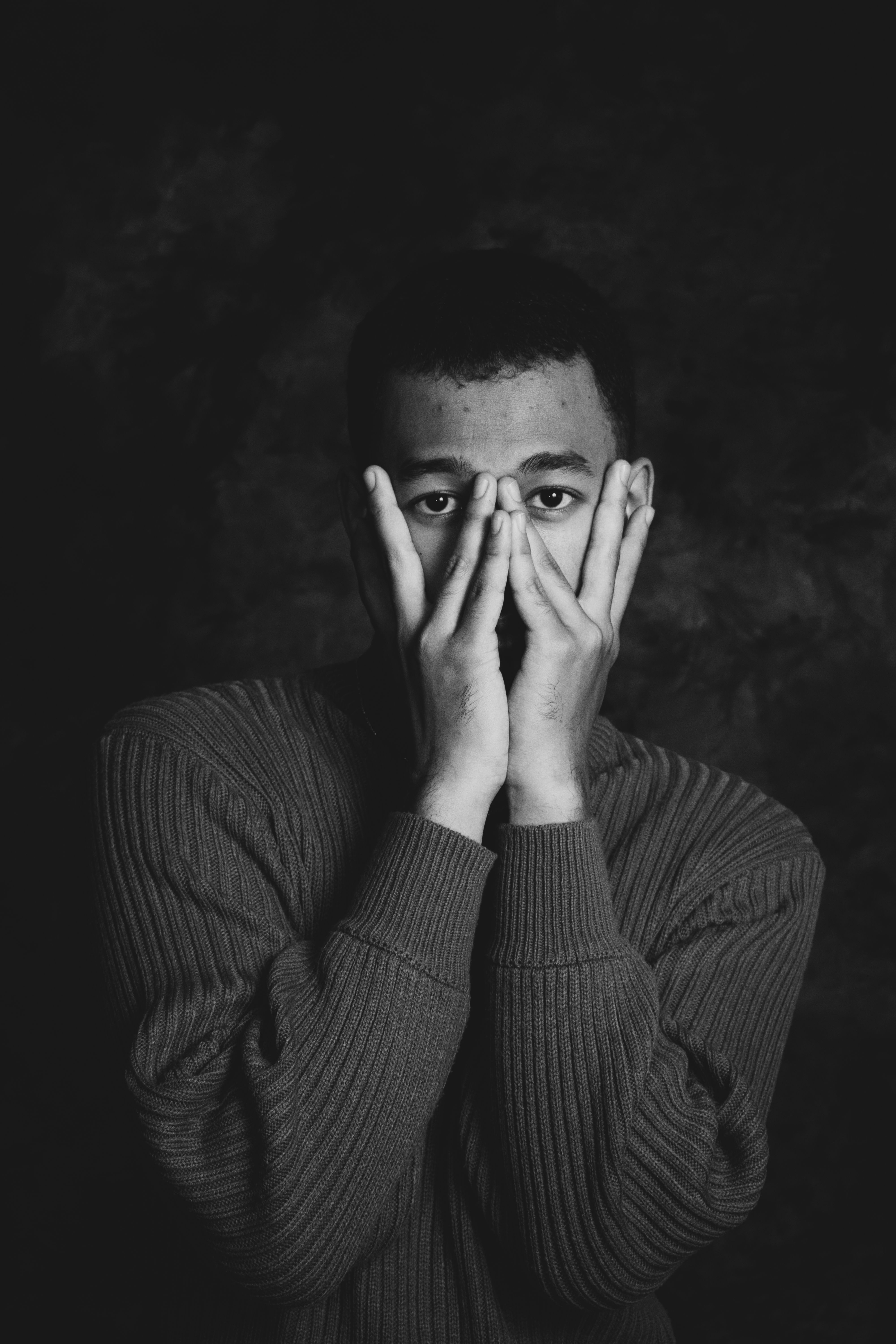 A man with his hands covering his face · Free Stock Photo
