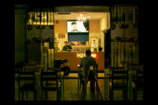 A man dines solo at an outdoor Korean restaurant at night in Santiago de Querétaro, Mexico.
