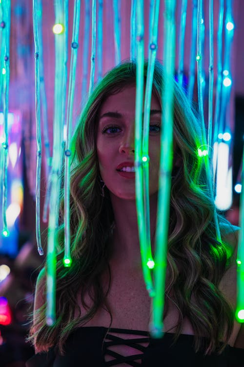 Young Blonde Woman Behind Neon Lights