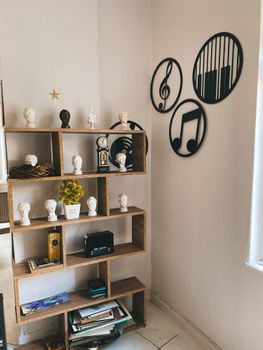 Modern corner with a wood bookcase, music-themed wall art, and decorative accents.