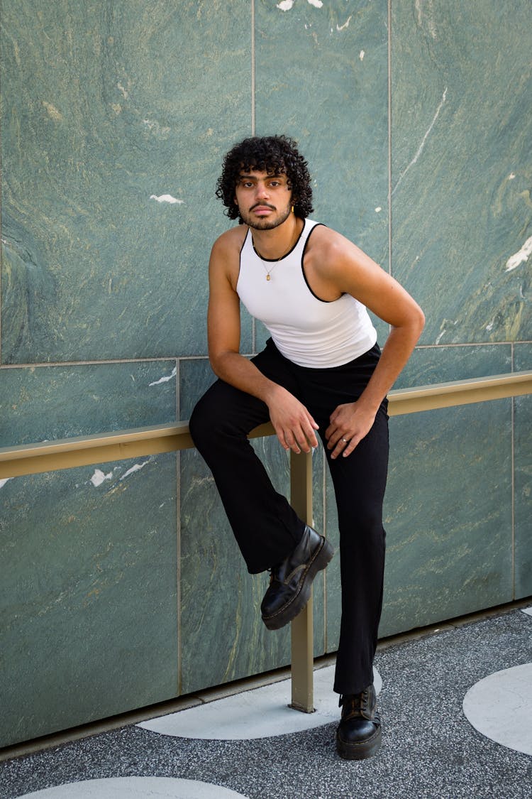 Young Man With Moustache Posing Near Wall