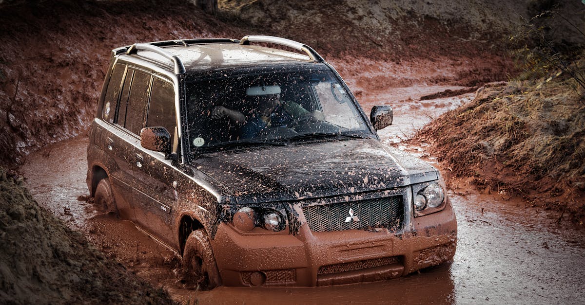 A Mitsubishi SUV challenging a muddy off-road track, showcasing adventure and rugged performance.