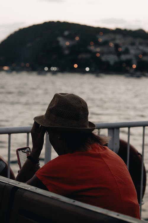 A Person Sitting with a Smartphone