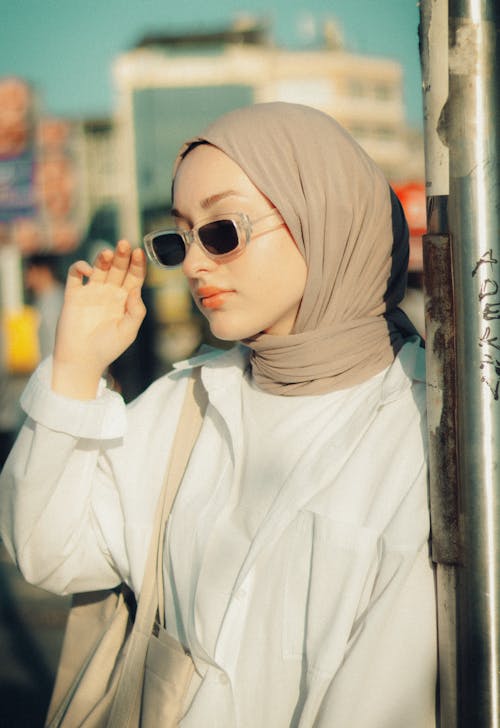 A Woman Wearing Sunglasses and a Headscarf