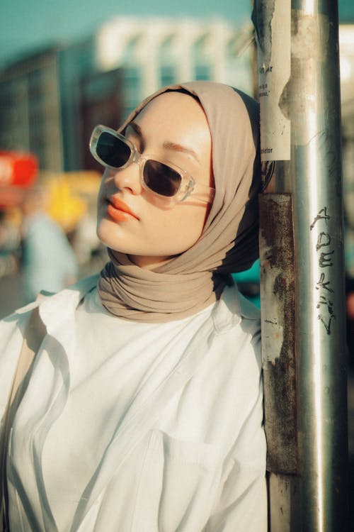 A Woman Wearing Sunglasses in a City