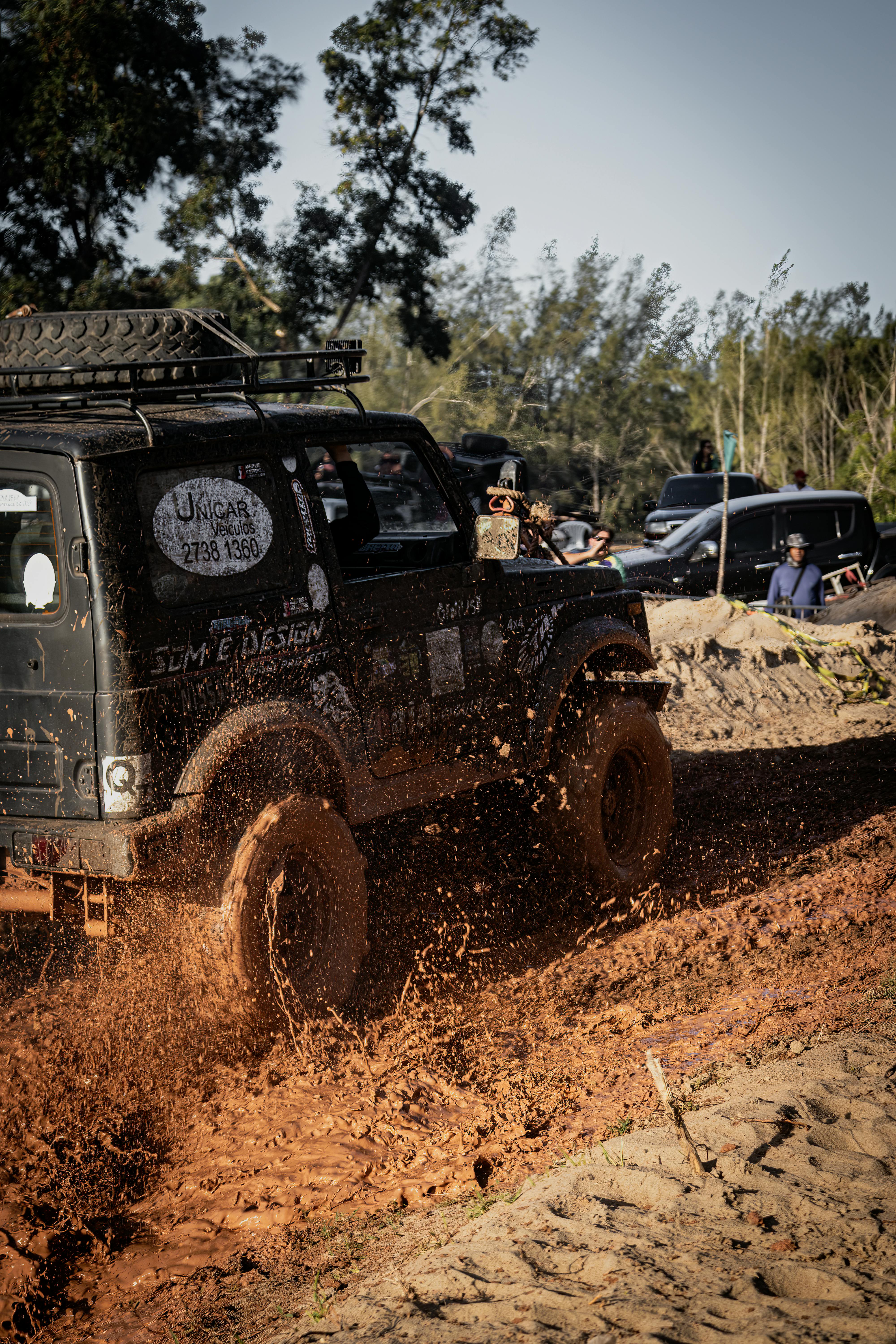 Dynamic off-road scene of a rugged SUV driving through muddy terrain, showcasing adventure and excitement.