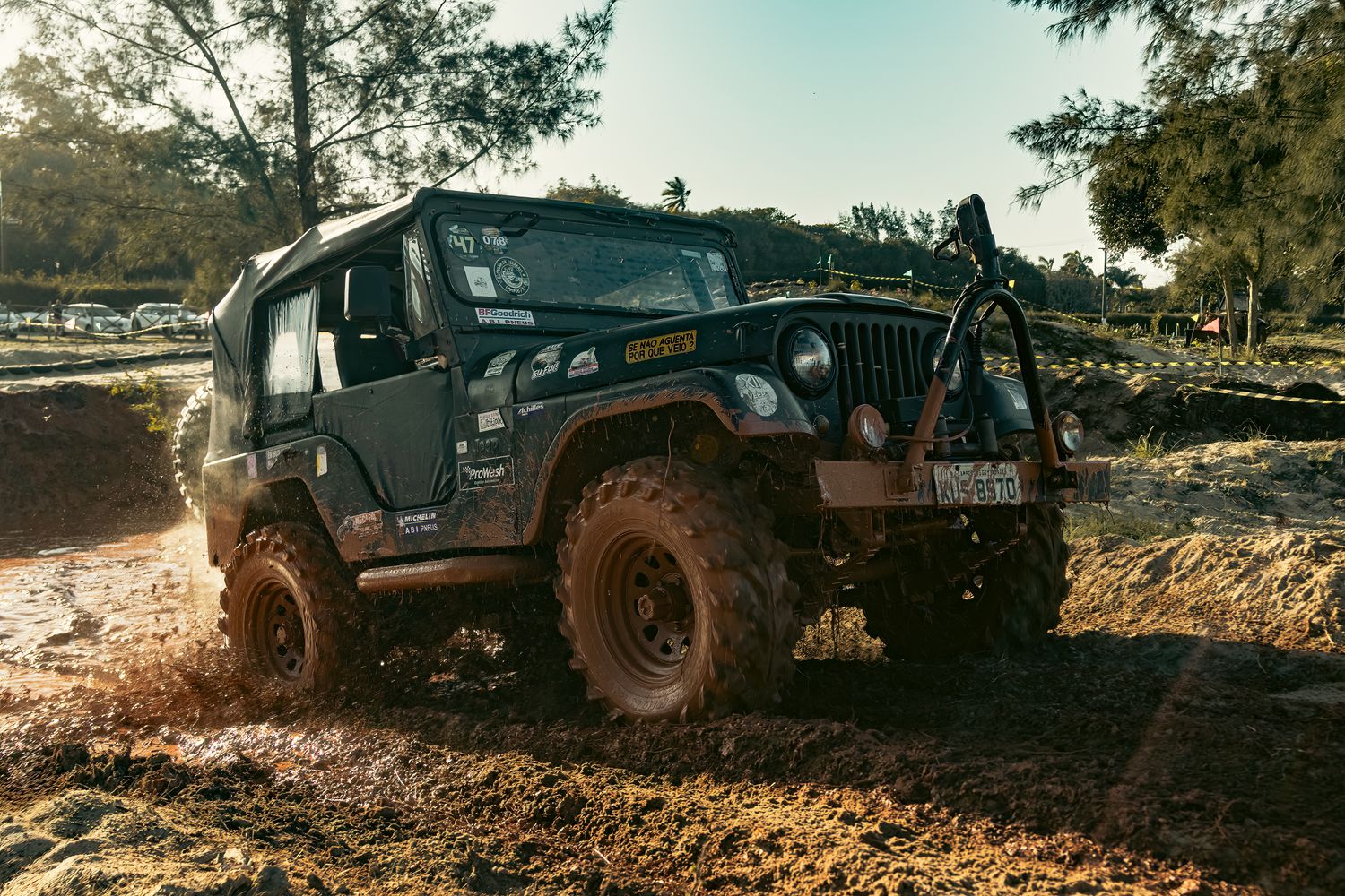 Off-road Jeep splashing through deep mud where traction boards would aid self-recovery