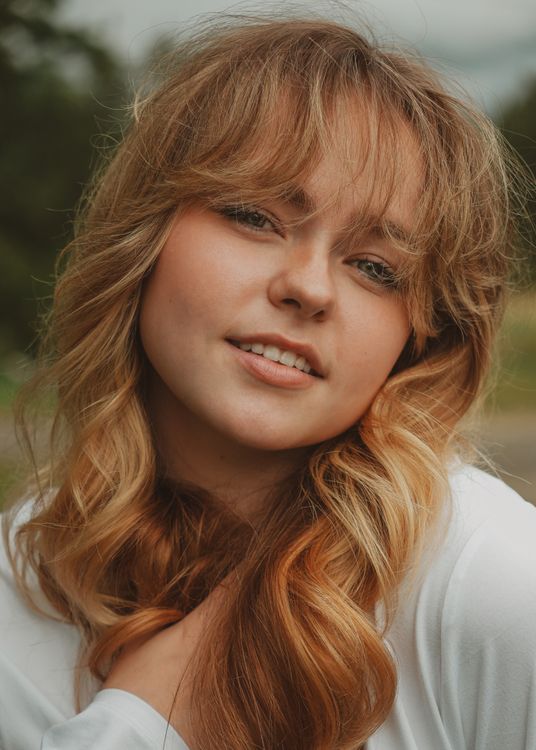 Portrait of Smiling Young Woman in Nature · Free Stock Photo