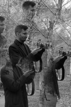 Abstract black and white portrait of a photographer in a forest.