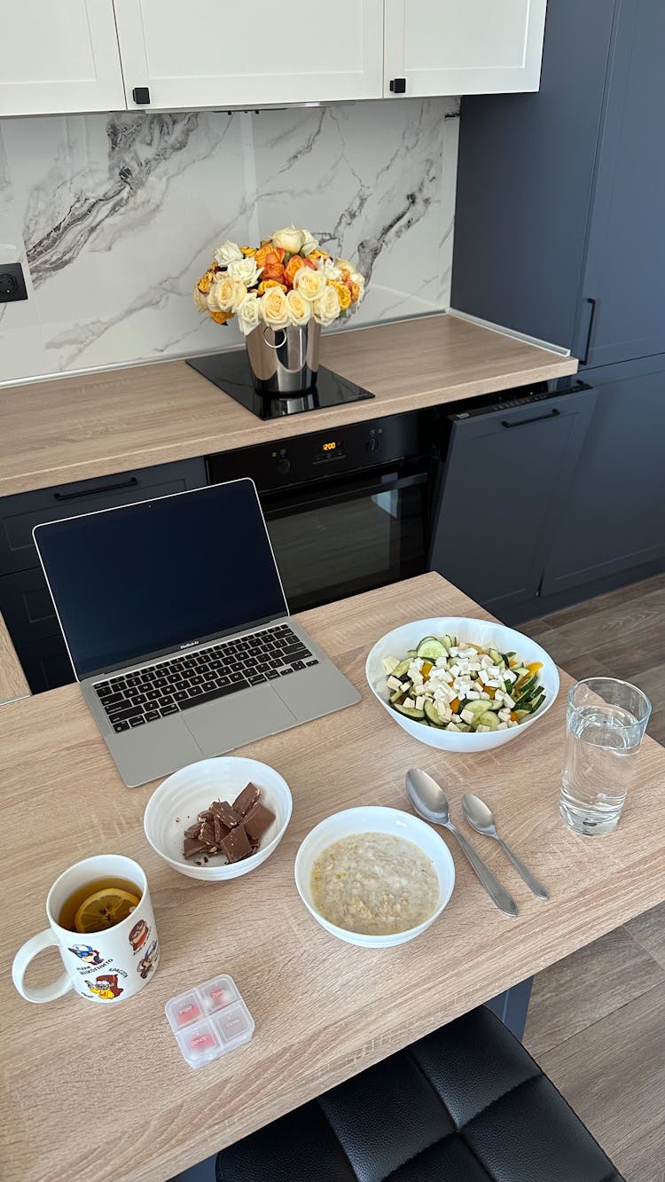 Modern Laptop And Food On Table In Home Office