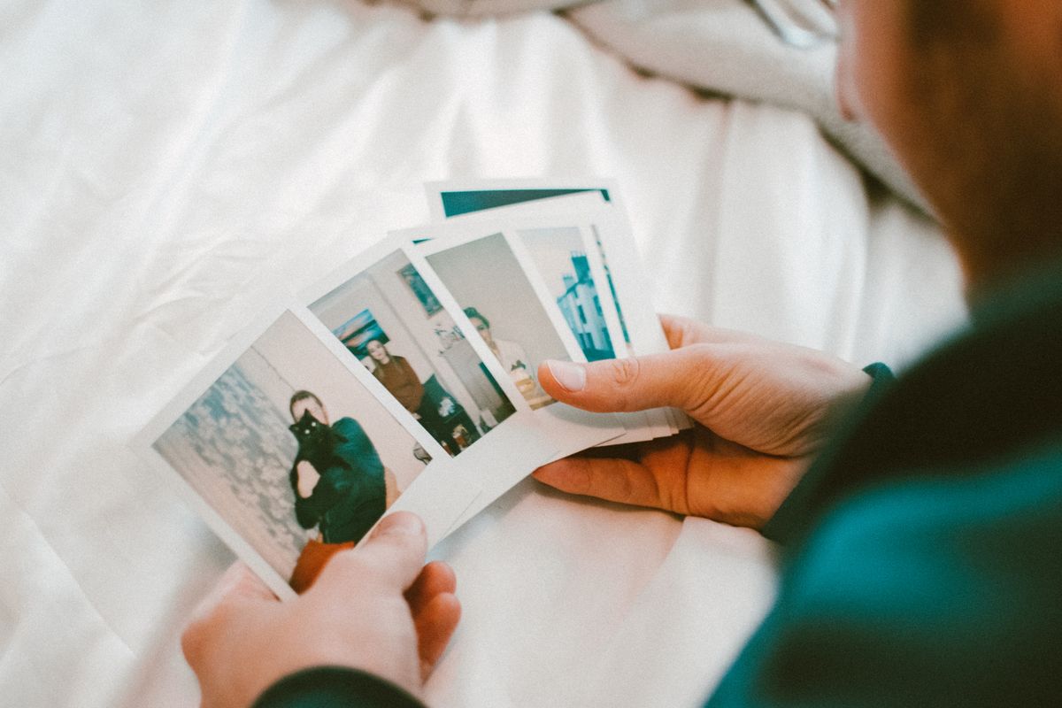 Hands holding instant photos from an event