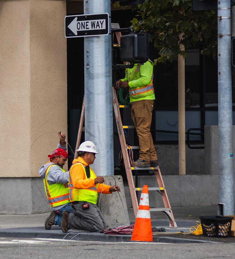 Workers Working Near Pole By Street